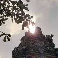 Some kind of temple, photographed from the ground looking up, partly covering the sun Some kind of temple, photographed from the ground looking up, partly covering the sun