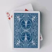 A stack of playing cards, face down except for the 5 of diamonds that's sticking out A stack of playing cards, face down except for the 5 of diamonds that's sticking out
