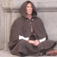 A man wearing a brown cloak, sitting on the ground like a beggar A man wearing a brown cloak, sitting on the ground like a beggar